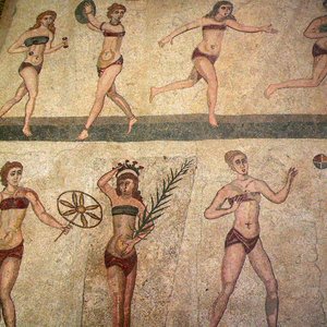 The so-called 'bikini girls' mosaic: young women exercise and receive prizes. Room of the Ten Maidens, Villa Romana del Casale near Piazza Armerina in Sicily, 4th century CE; the mosaic remains in situ. The nickname depends on a modern resemblance of clothing and is not an ancient term.