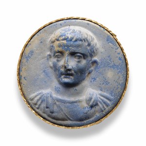 Glass disc with a portrait identified as Tiberius. Auction collection; early first century CE. Identification and archaeological provenance require independent confirmation.
