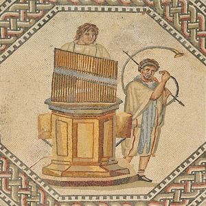 Musicians with a hydraulis and cornu. Floor mosaic from the Roman villa at Nennig on the Moselle, Germany, mid-3rd century CE. The scene shows a water organ and a curved brass instrument in the context of public games.