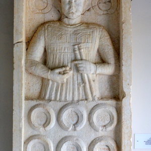 Tombstone stele dedicated to the musician L. Cornelia Sabin and in memory of his many "musical victories". Found embedded in the northeast gate of the Hexamilion wall,Isthmia. Isthmian Archaeological Museum,Greece IΣ 69-1. Mid-2nd century AD