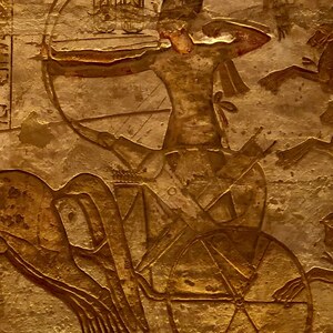 Ramesses II in a chariot in a Battle of Kadesh scene, relief of the Abu Simbel temple.