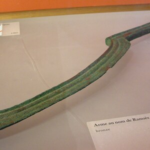 Egyptian khopesh: a sickle-shaped blade connected with New Kingdom weaponry and royal iconography. Louvre;.