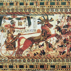 Tutankhamun striking enemies from a chariot: painting on a chest from tomb KV62. The image shows the royal ideology of chariot warfare.