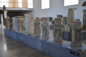 A row of funerary stones, altars and architectural fragments in the Steinhalle, Landesmuseum Mainz.