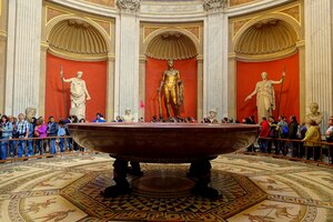 The Sala Rotonda of the Pio-Clementino Museum with large ancient sculpture and the porphyry basin.
