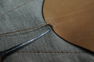 Marking a leather part before stitching.