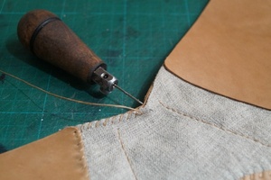 Punching holes along the join line.