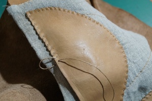 Stitching the toe area and checking the edge.