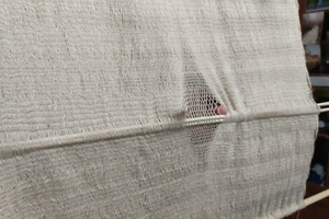 Sprang fabric: the working closure runs through the middle of the textile.