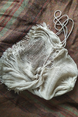 Finished reconstruction: elastic fabric, ties and the edge of the cap.