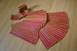 Set of leather pteruges after dyeing and edging, before assembly.