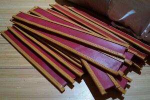 Leather pteruges with finished edges and awl-made holes for hand stitching.