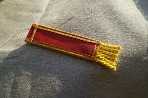 Sample detail finish: leather edging, hand stitching and cords.