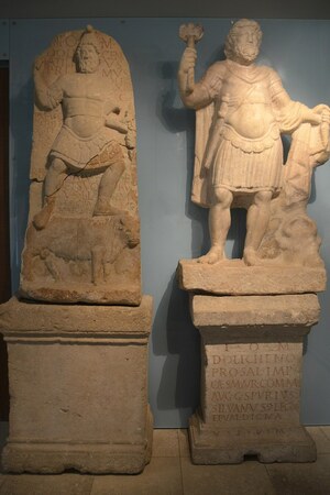Карнунт: Limestone relief (left) and marble statue (right) of Jupiter Dolichenus, Antonine-Sever...; предмет материальной культуры или музейная находка, связанный с памятником, римский период или локальный археологический контекст.