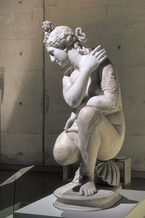 Statue of crouching Aphrodite, shown in an exhibition at Lugdunum Museum.