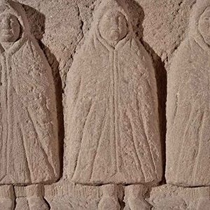Relief of three hooded figures (genii cucullati) from the area of Hadrian’s Wall, second century CE.